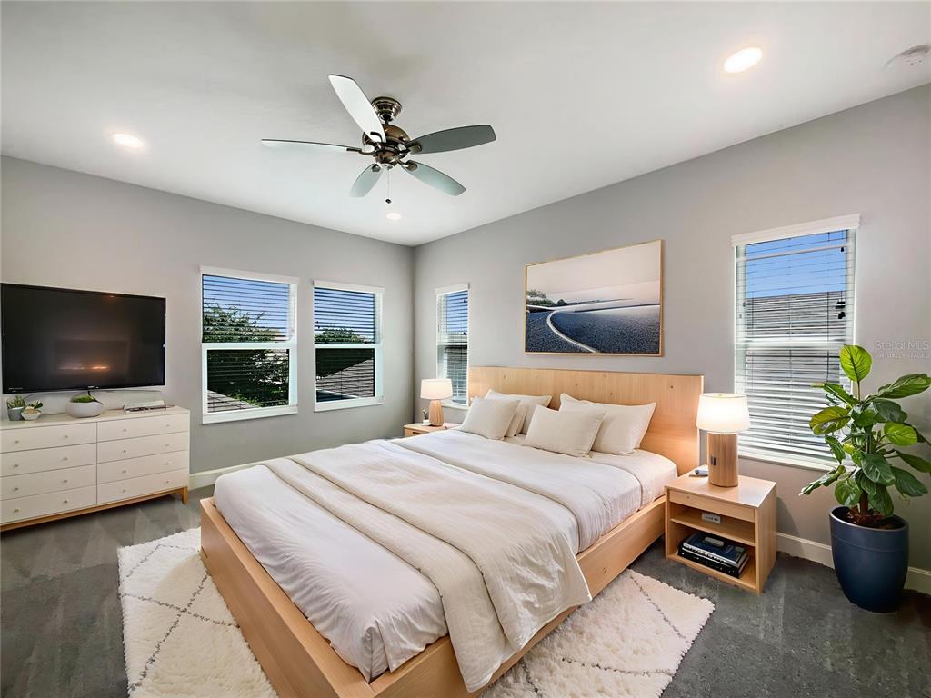 705 Winterside Drive Apollo Beach, FL 33572 - Photo 9 of 30 a bedroom with a large bed and a flat screen tv