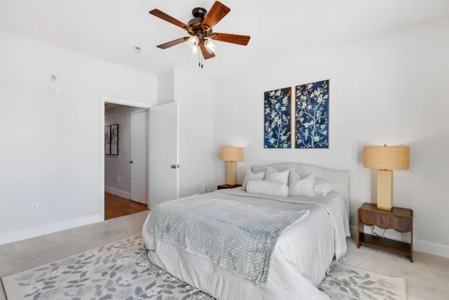 a bedroom with a bed and a chandelier