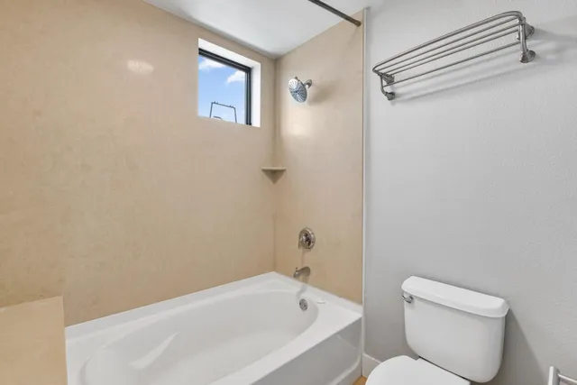a bathroom with a toilet and a bathtub