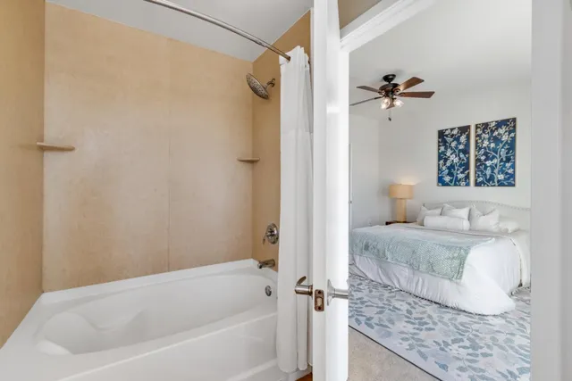 a bathroom with a granite countertop sink a toilet and shower