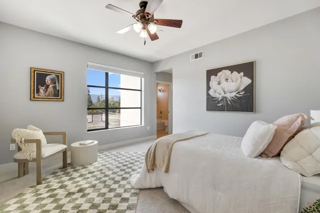 a bedroom with a bed and a painting on the wall