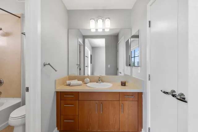a bathroom with a sink vanity and a mirror