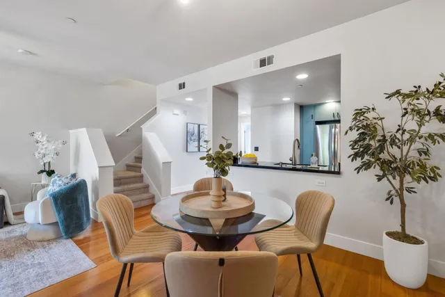a dining room with furniture and wooden floor