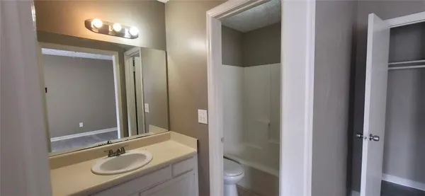 a bathroom with a sink double vanity granite tub and shower
