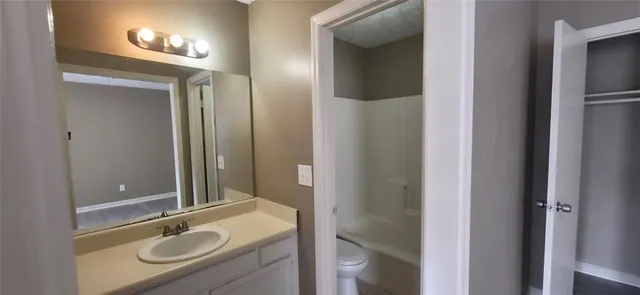 a bathroom with a sink double vanity granite tub and shower