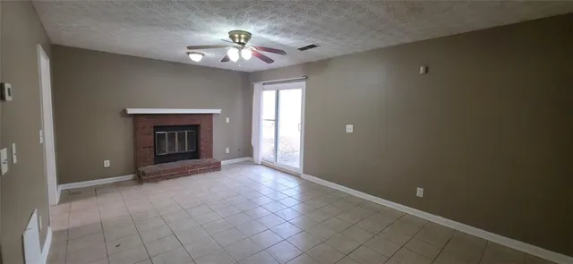 a view of an empty room with a fireplace