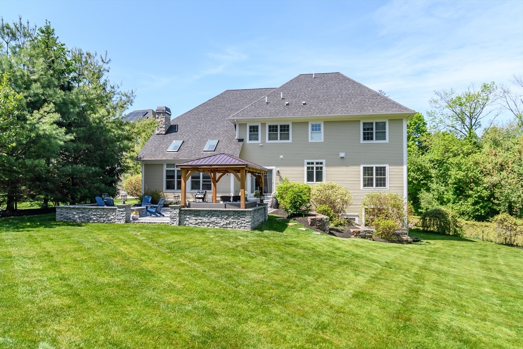2 Hunters Lane Natick, MA 01760 - Photo 40 of 40 a front view of a house with a garden and trees