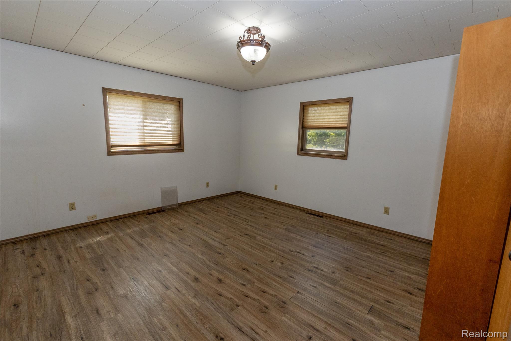 5761 Genesee Road Lapeer, MI 48446 - Photo 14 of 52 Bright room featuring wood-finish flooring, white walls, and a textured ceiling