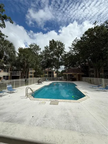 a view of outdoor space with swimming pool and seating