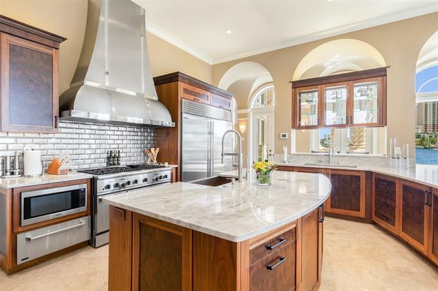 a bed sitting in a spacious bedroom next to a window