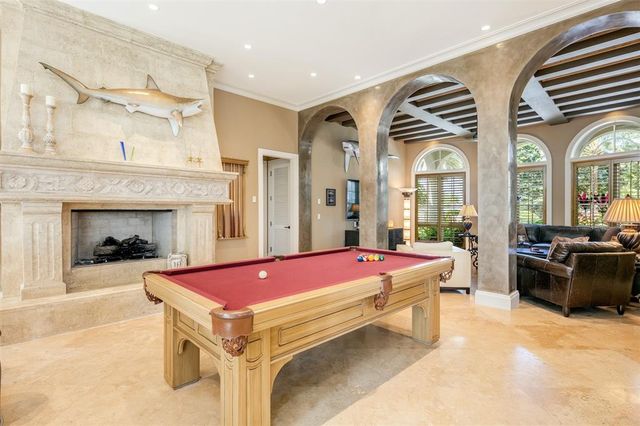 a kitchen with stainless steel appliances white cabinets and a window