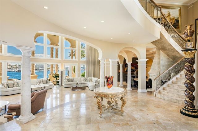 a view of a dining room with furniture a chandelier and a rug
