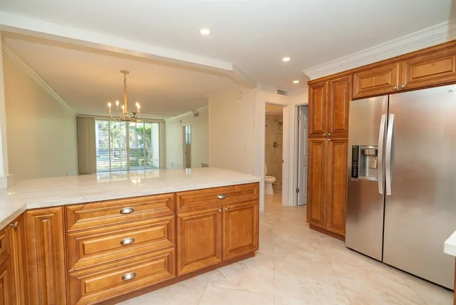 a bathroom with a granite countertop sink mirror and a shower
