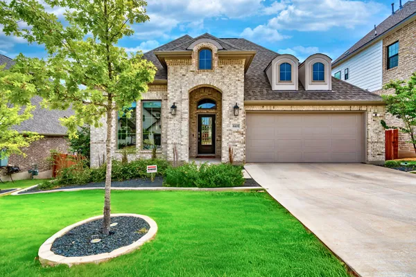 a front view of a house with a yard