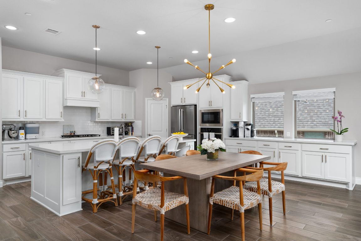 6105 Fadden Road Austin, TX 78738 - Photo 12 of 40 a kitchen with a dining table chairs stainless steel appliances and cabinets