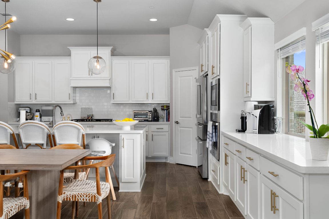 6105 Fadden Road Austin, TX 78738 - Photo 13 of 40 a kitchen with a sink refrigerator and cabinets