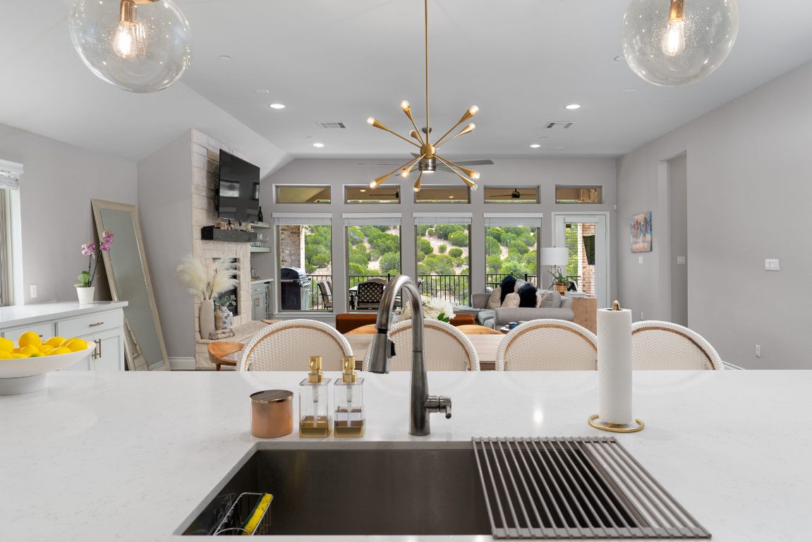 6105 Fadden Road Austin, TX 78738 - Photo 40 of 40 a very nice looking dining room with a large window and chandelier