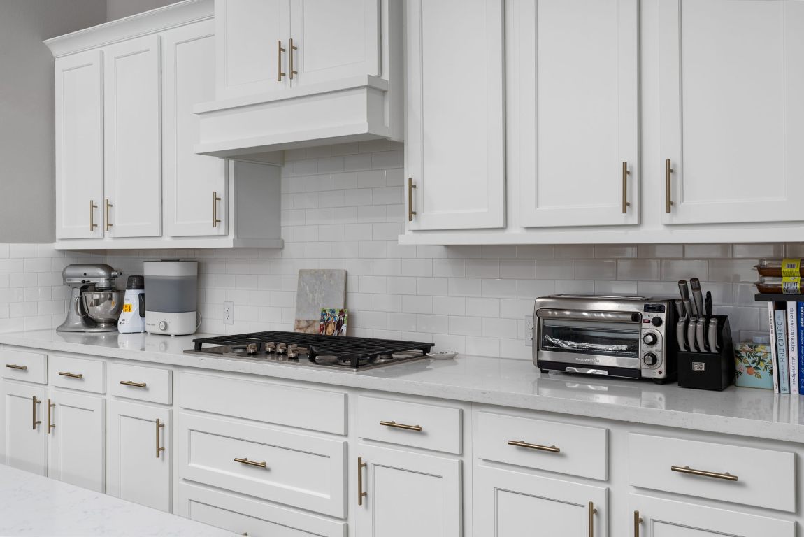 6105 Fadden Road Austin, TX 78738 - Photo 15 of 40 a kitchen with white cabinets and appliances