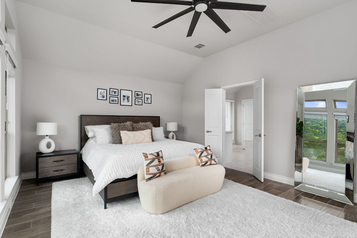 6105 Fadden Road Austin, TX 78738 - Photo 17 of 40 a bedroom with a bed and ceiling fan
