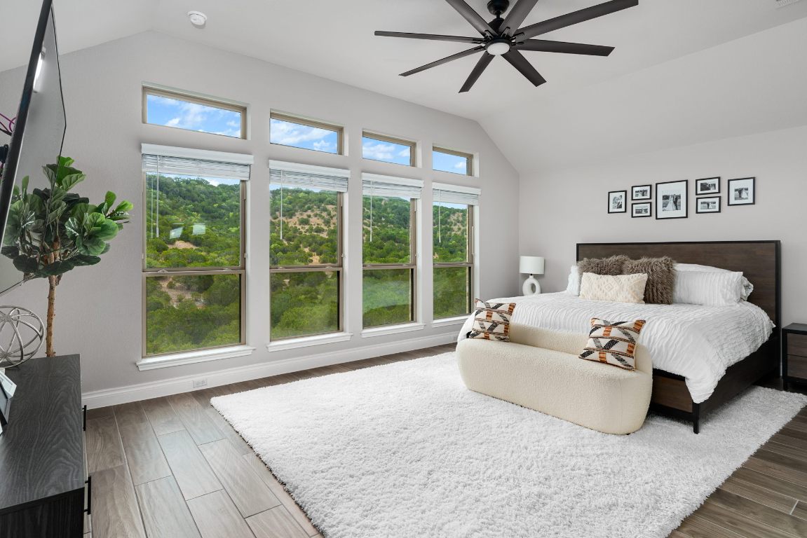 6105 Fadden Road Austin, TX 78738 - Photo 18 of 40 a spacious bedroom with a large bed and a large window