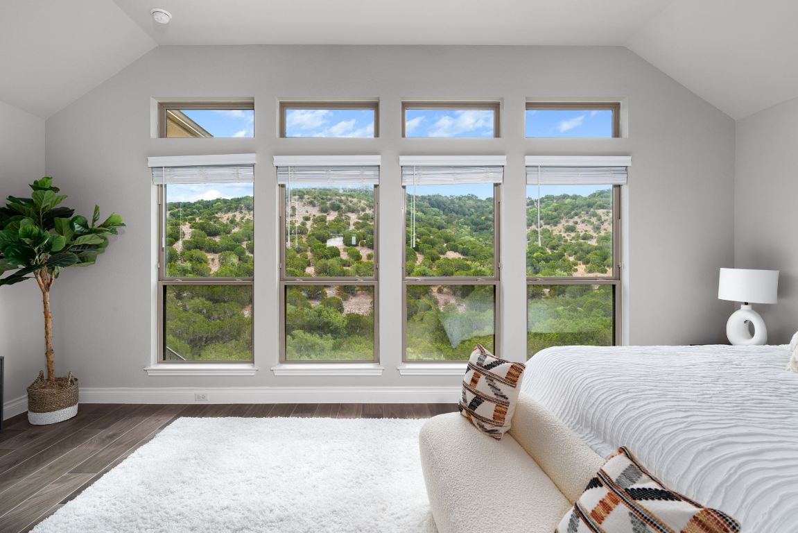 6105 Fadden Road Austin, TX 78738 - Photo 20 of 40 a bedroom with a bed and a large window