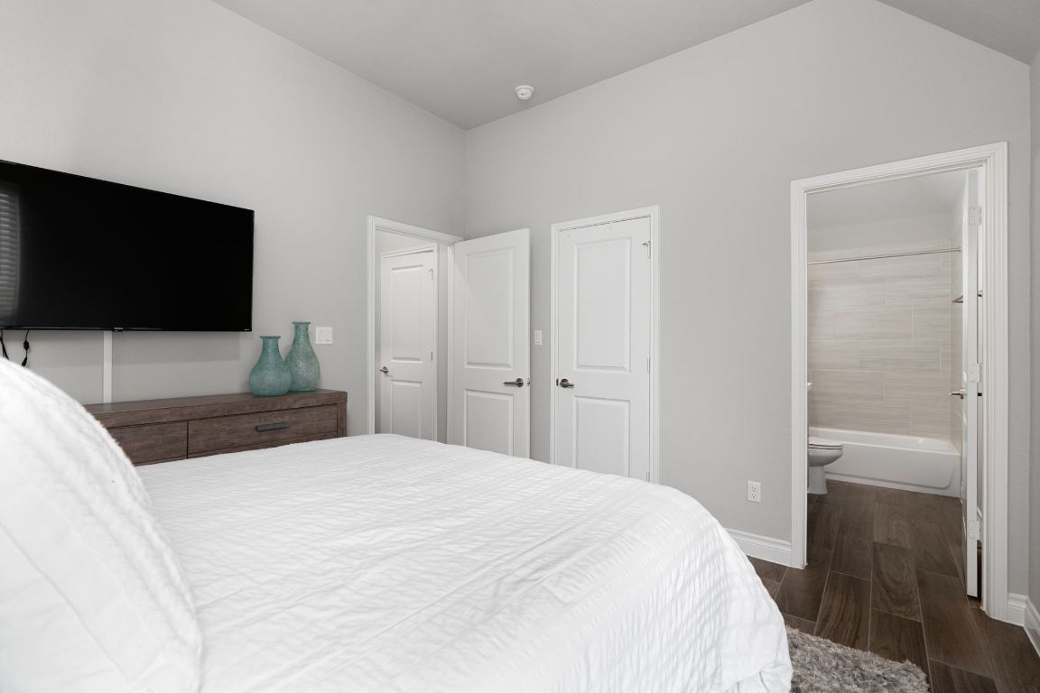 6105 Fadden Road Austin, TX 78738 - Photo 25 of 40 a bedroom with a bed and a flat screen tv