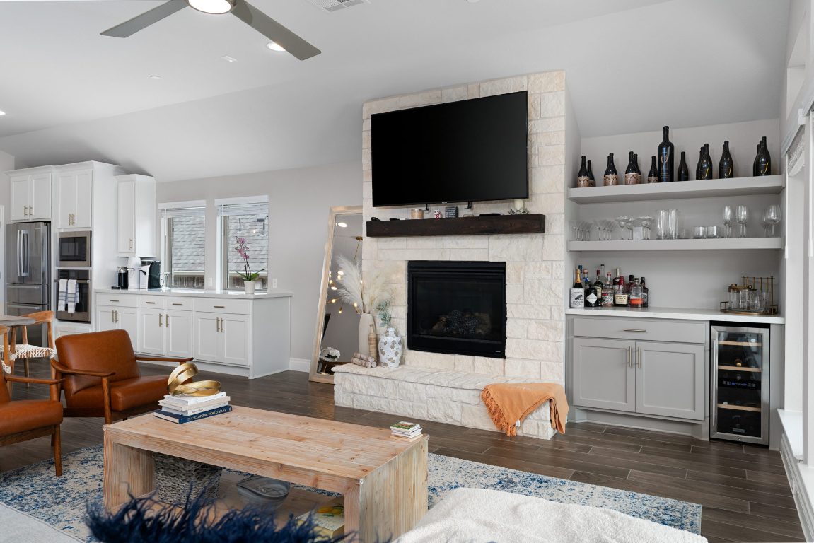 6105 Fadden Road Austin, TX 78738 - Photo 8 of 40 a living room with furniture a flat screen tv and kitchen view
