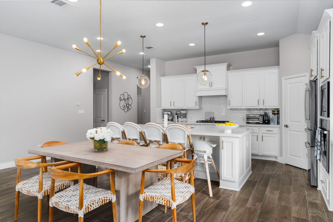 6105 Fadden Road Austin, TX 78738 - Photo 10 of 40 a kitchen with a table and chairs in it