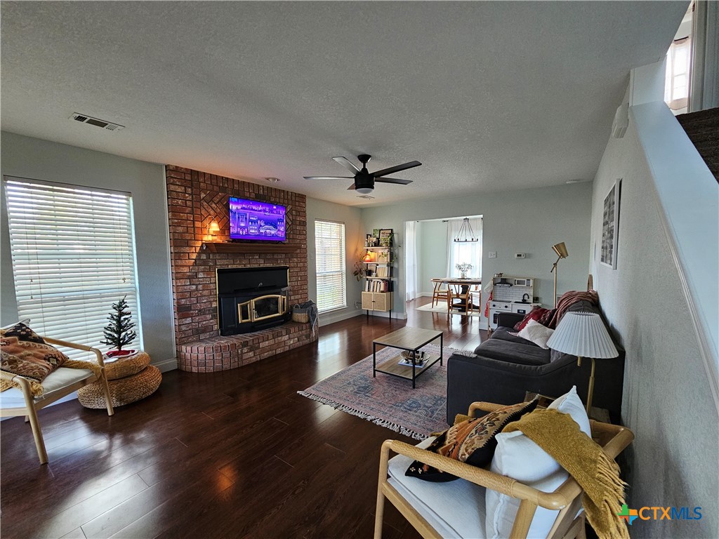 963 Benchmark Trail Belton, TX 76513 - Photo 2 of 6 a living room with furniture flat screen tv and a fireplace