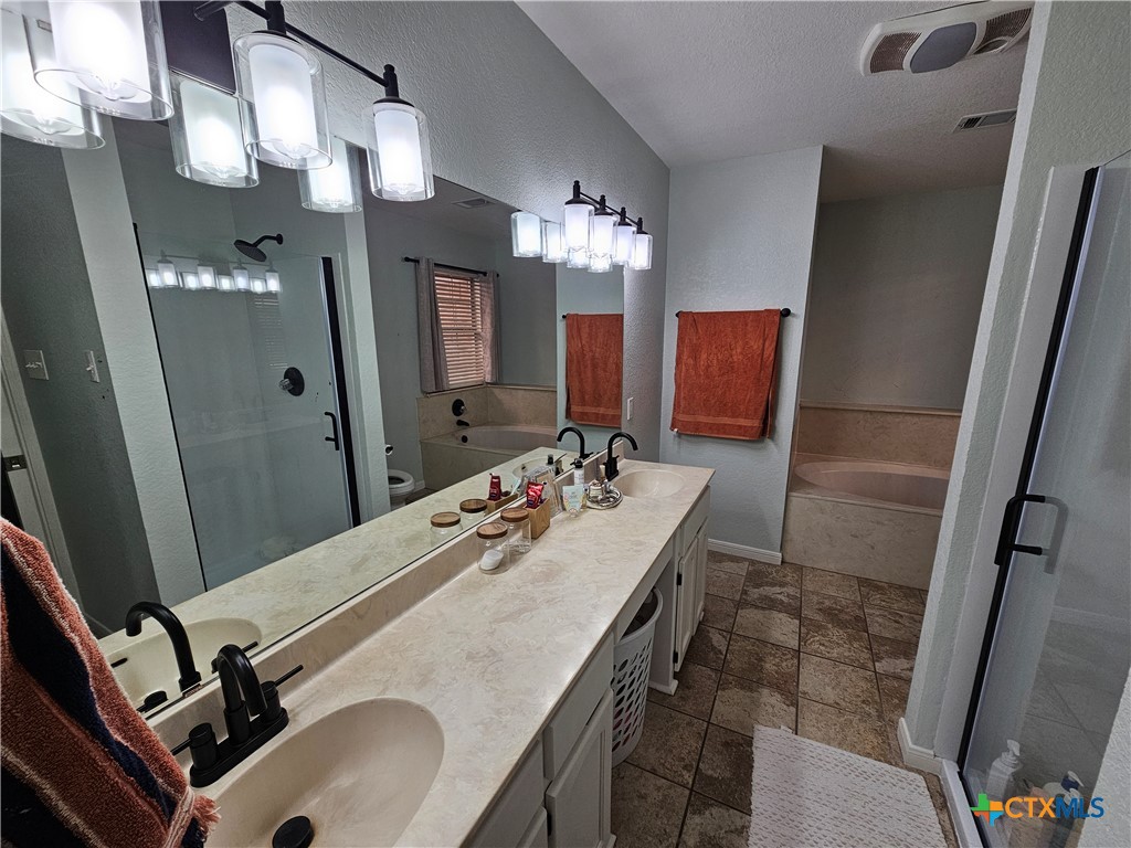 963 Benchmark Trail Belton, TX 76513 - Photo 4 of 6 a bathroom with a sink double vanity granite and a mirror