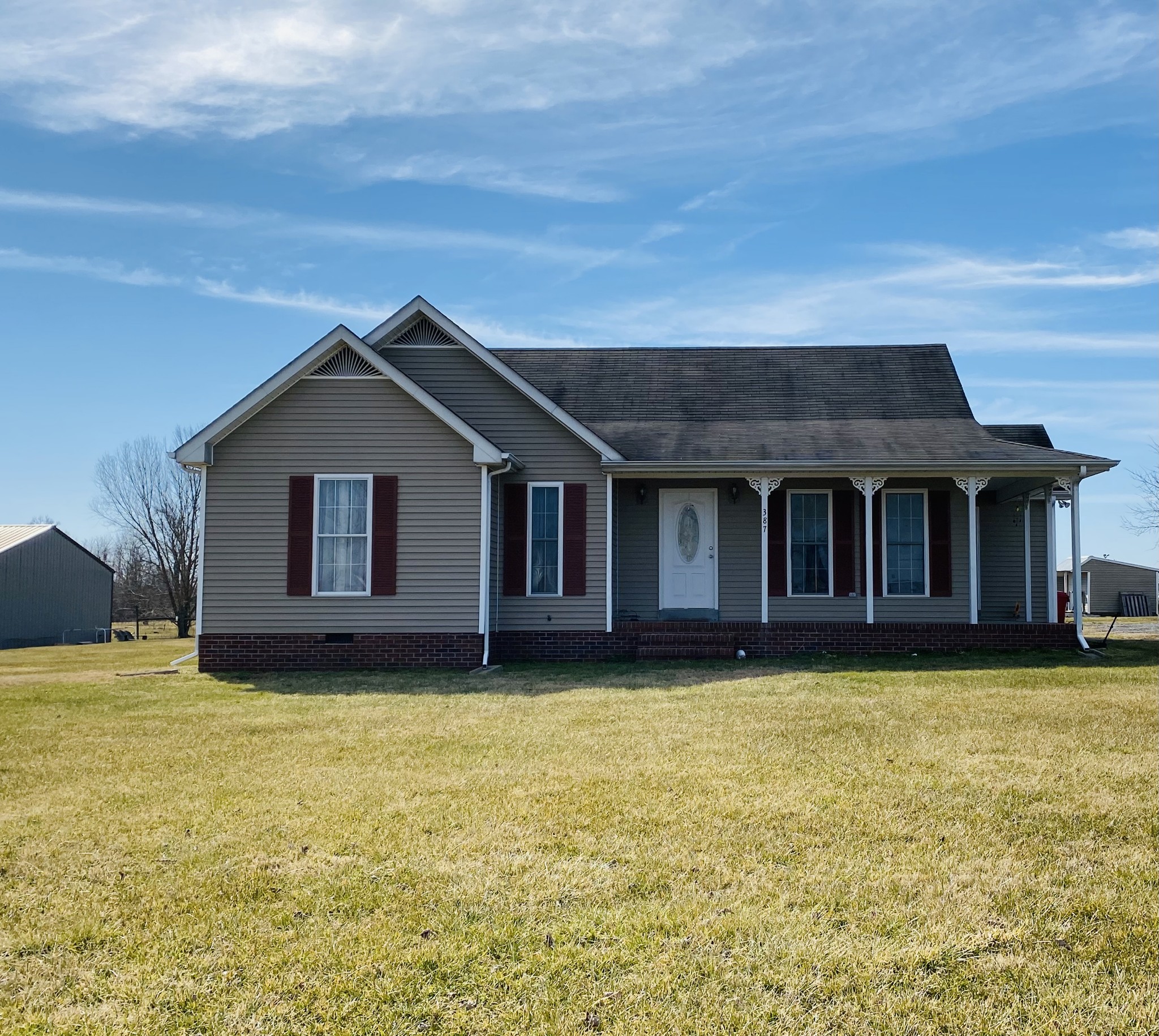 387 Garrett Road Lafayette, TN 37083 - Photo 1 of 17 a house with swimming pool in front of it
