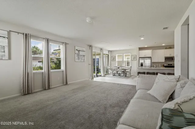 a view of a living room a window and a kitchen