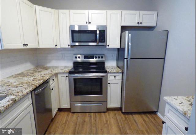 603 Quail Road Marlton, NJ 08053 - Photo 2 of 15 a kitchen with granite countertop a refrigerator stove and microwave