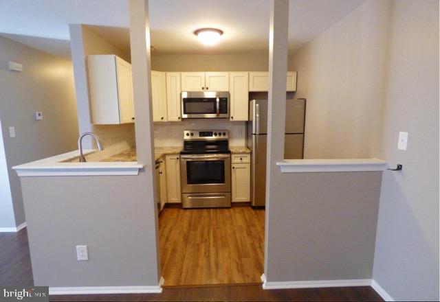 603 Quail Road Marlton, NJ 08053 - Photo 3 of 15 a kitchen with stainless steel appliances a refrigerator and a stove