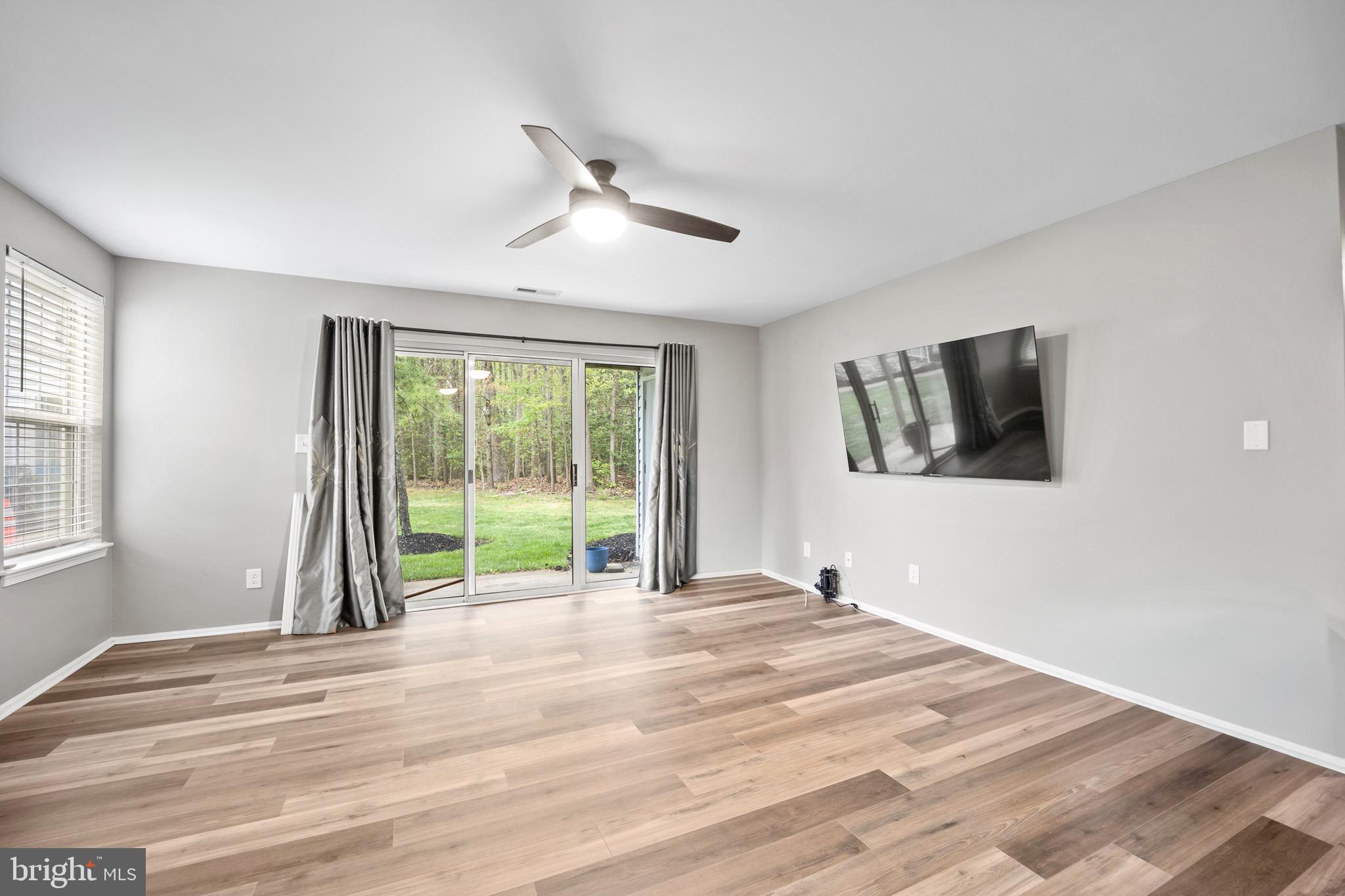 603 Quail Road Marlton, NJ 08053 - Photo 4 of 15 a view of a livingroom with wooden floor and a ceiling fan
