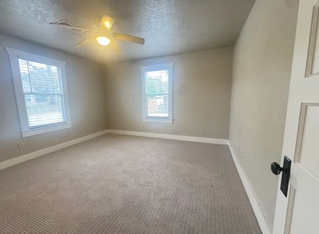 a view of empty room with windows