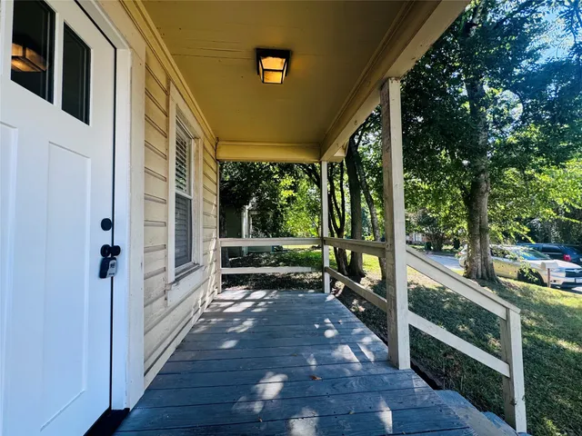 a view of a porch with wooden floor and outdoor space