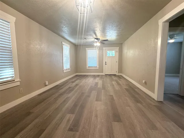 wooden floor in an empty room with a window