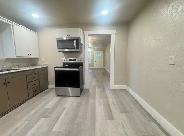 a kitchen with stainless steel appliances granite countertop a stove and a sink