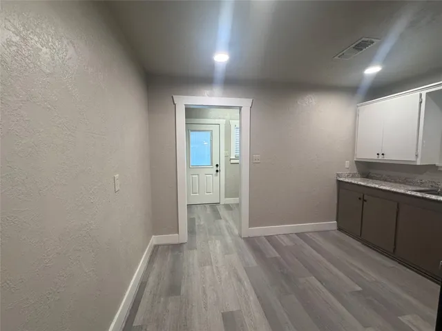 a view of a kitchen with a dishwasher cabinets and wooden floor