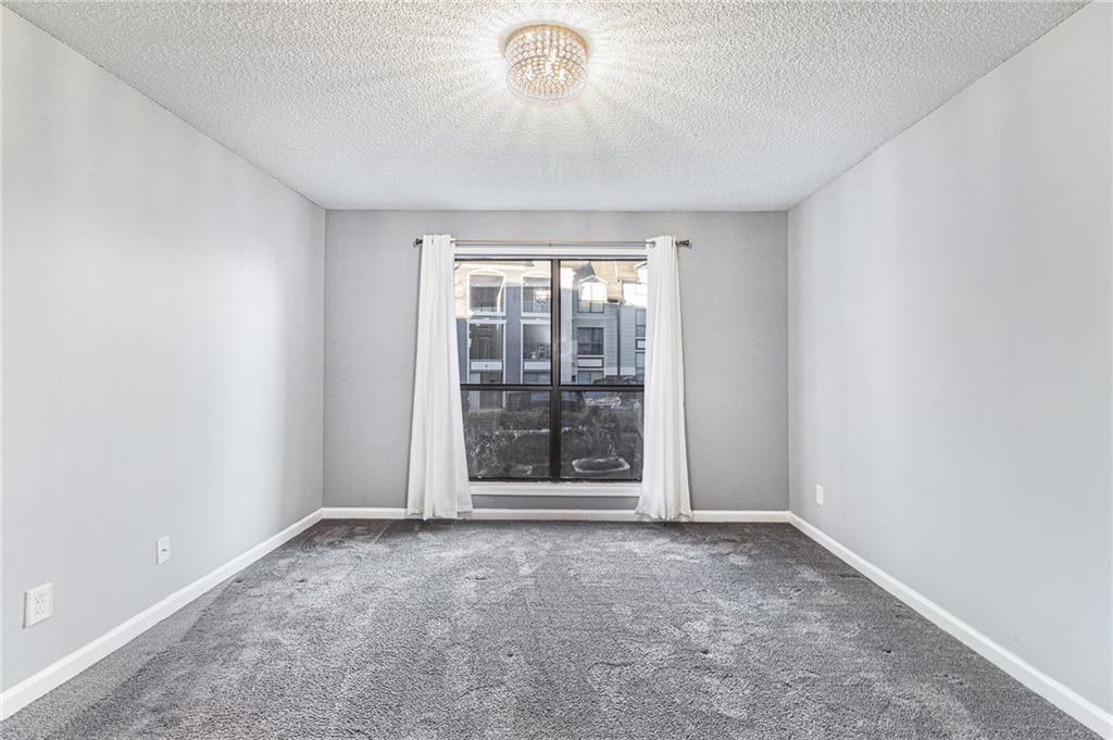 2657 Lenox Road Northeast, Unit C38 Atlanta, GA 30324 - Photo 11 of 20 an empty room with a empty space and windows