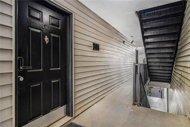 a view of a house with a door and wooden bench