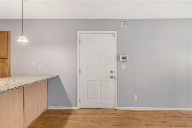 a view of a kitchen with a sink and a refrigerator