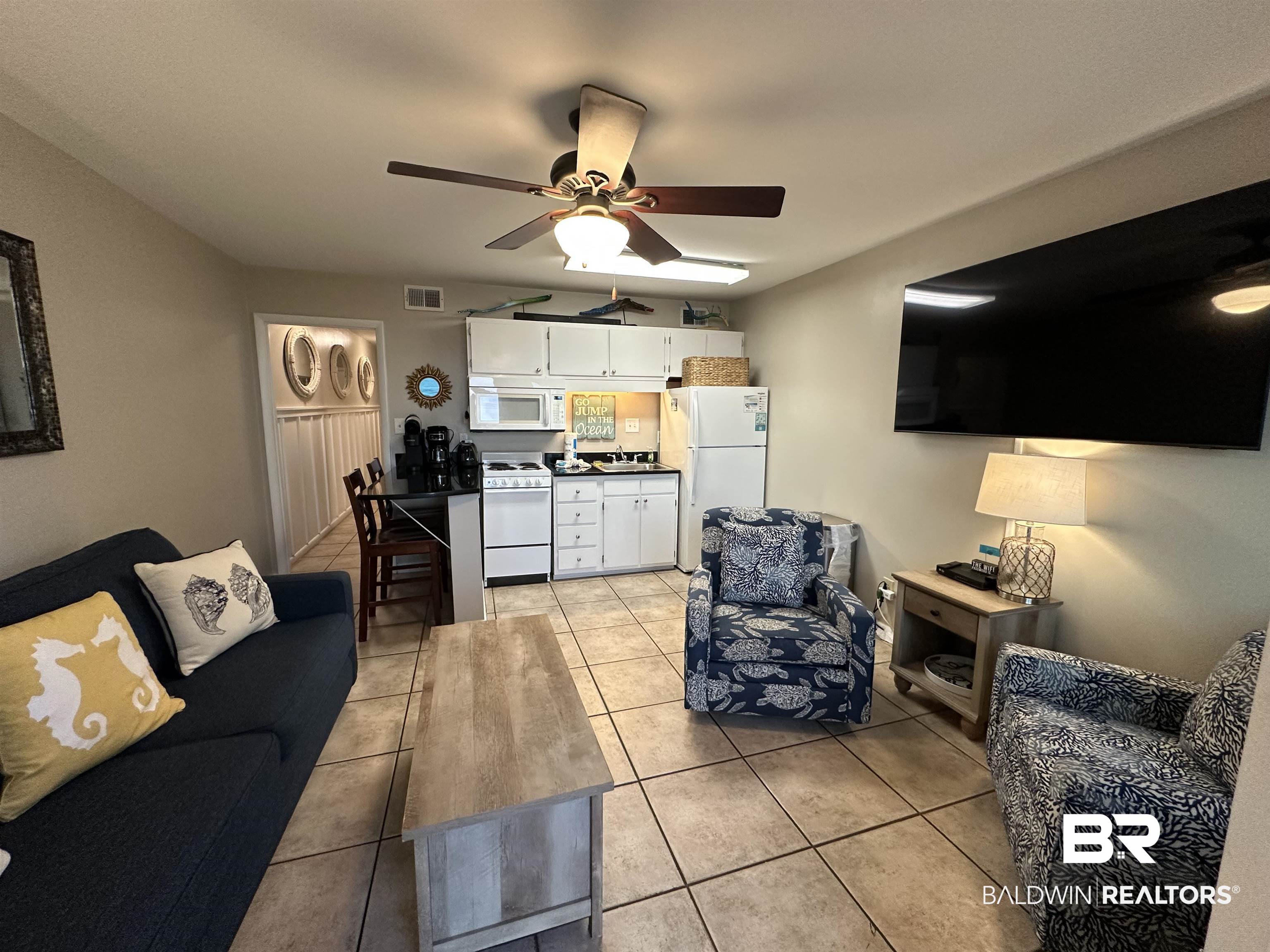 400 Plantation Road, Unit 2202 Gulf Shores, AL 36542 - Photo 14 of 26 Living area featuring light tile patterned floors and ceiling fan