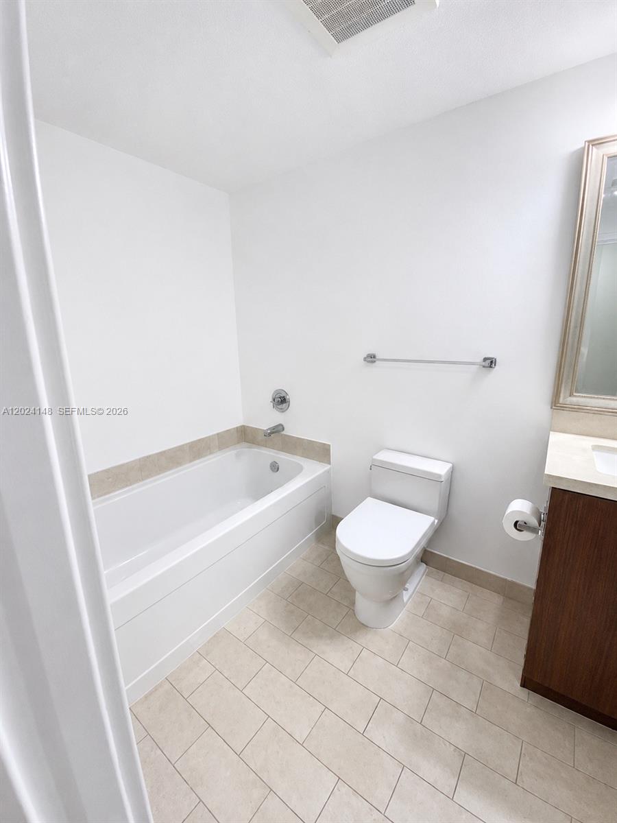 79 Southwest 12th Street, Unit 1405S Miami, FL 33130 - Photo 5 of 7 a bathroom with a toilet and a shower