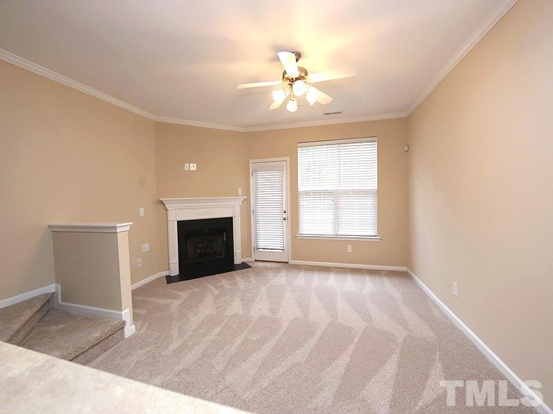 7732 Winners Edge Street Raleigh, NC 27617 - Photo 6 of 12 a view of an empty room with window and fireplace