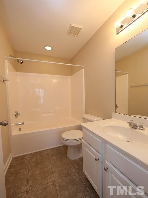 7732 Winners Edge Street Raleigh, NC 27617 - Photo 8 of 12 a bathroom with a sink a toilet and shower