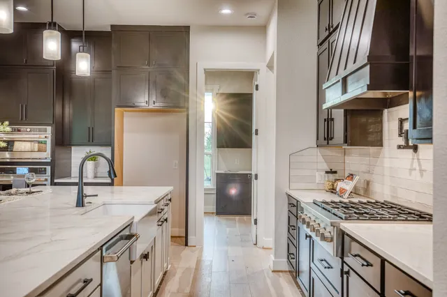 a kitchen with a sink stove and refrigerator