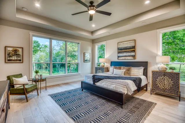 a bedroom with a bed wooden floor and window