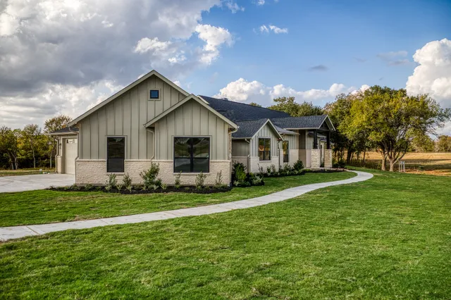 a front view of house with yard and green space
